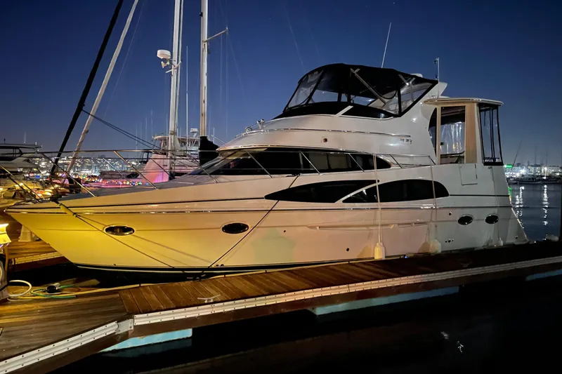 The Image of 2006 Carver 39 Motor Yacht docked at night, illuminated by marina lights. - 0