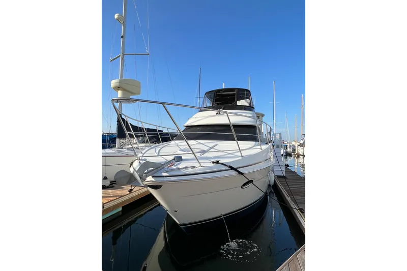 Slide: The Image of 2006 Carver 39 Motor Yacht docked at marina under clear blue sky. - 1