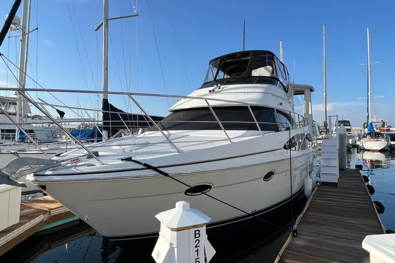 Slide: The Image of 2006 Carver 39 Motor Yacht docked at marina under clear blue sky. - 2