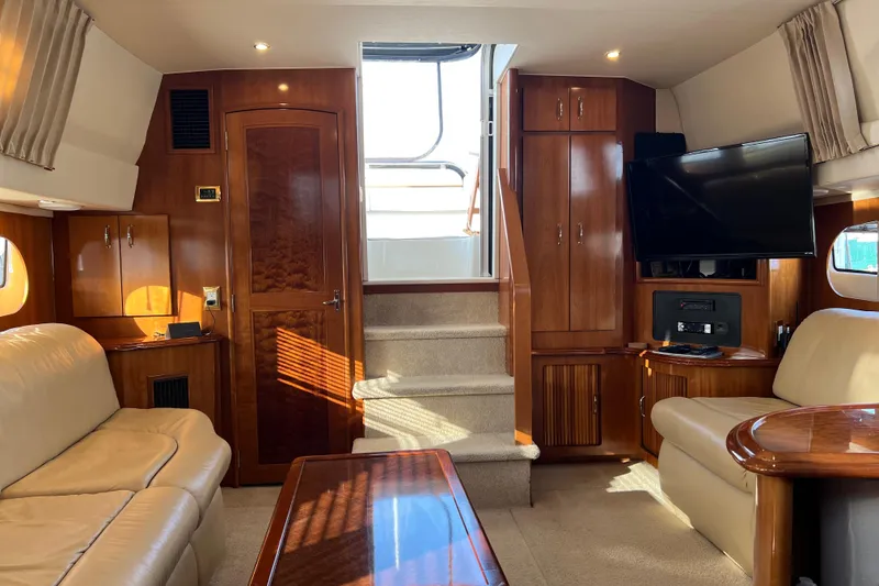 Slide: The Image of Luxurious interior of 2006 Carver 39 Motor Yacht with elegant wood finishes and plush seating. - 12