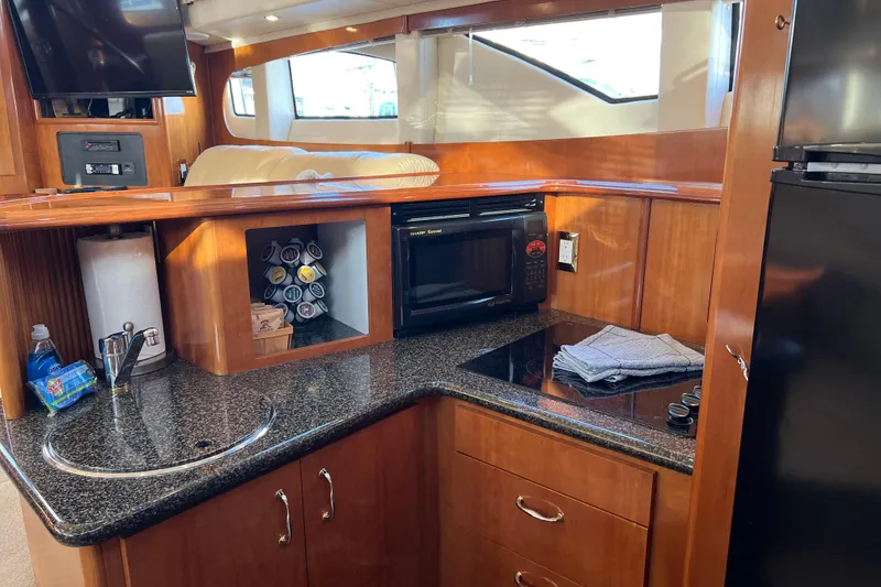 Slide: The Image of Interior of 2006 Carver 39 Motor Yacht kitchen with microwave, sink, and storage. - 13