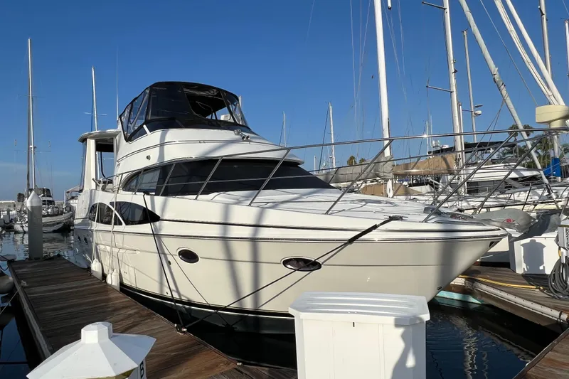 Slide: The Image of 2006 Carver 39 Motor Yacht docked at marina under clear blue sky. - 3