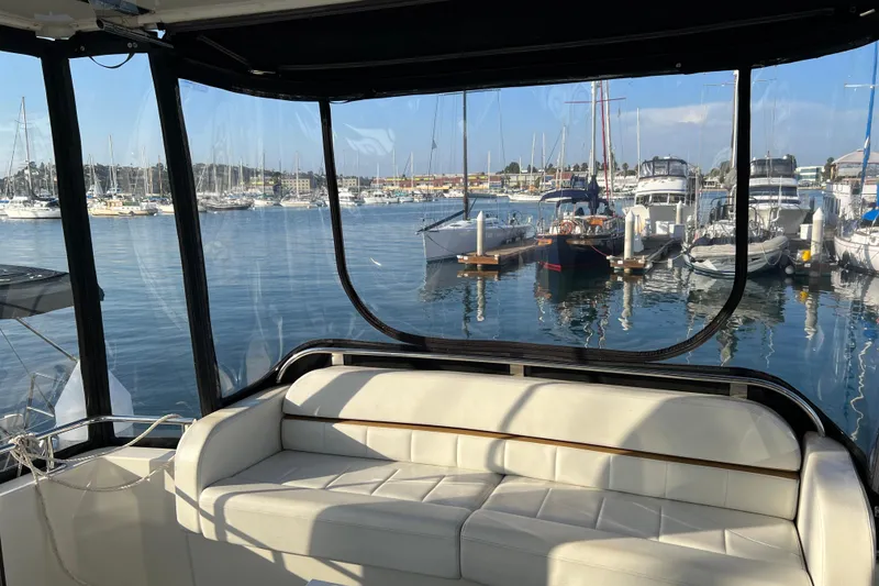 Slide: The Image of Interior view of 2006 Carver 39 Motor Yacht overlooking marina with docked boats. - 6