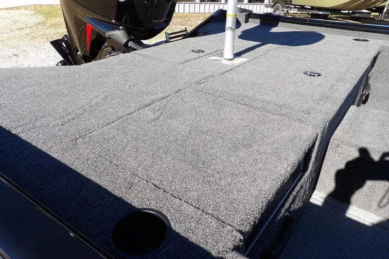 Slide: The Image of 2026 Lund 1875 Renegade boat deck with carpeted surface and motor detail. - 11