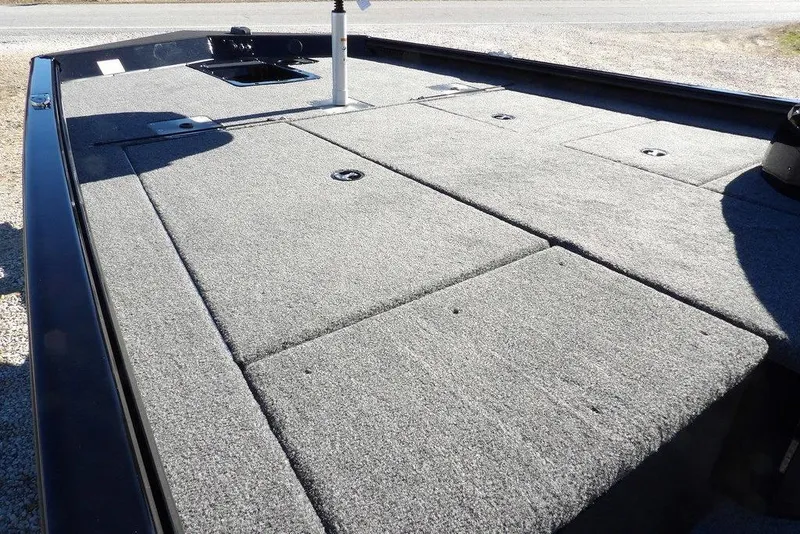 Slide: The Image of 2026 Lund 1875 Renegade boat deck with carpeted surface and storage compartments. - 14