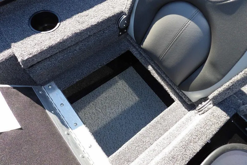 Slide: The Image of 2026 Lund 1875 Renegade boat interior with storage compartment and cup holder. - 15