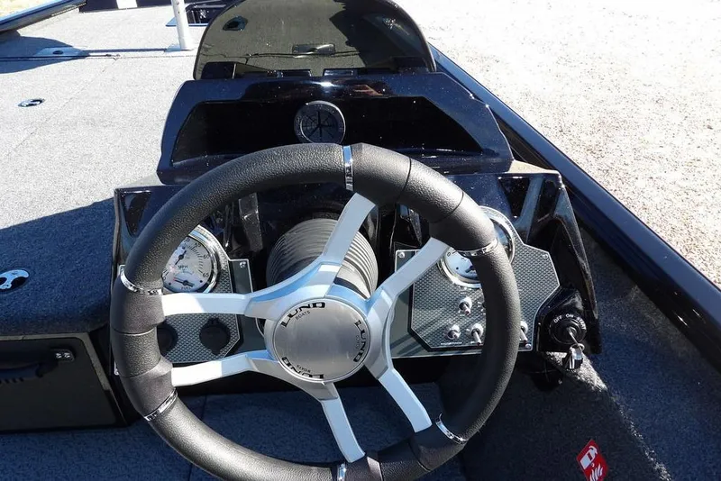 Slide: The Image of 2026 Lund 1875 Renegade boat dashboard with steering wheel and gauges. - 23