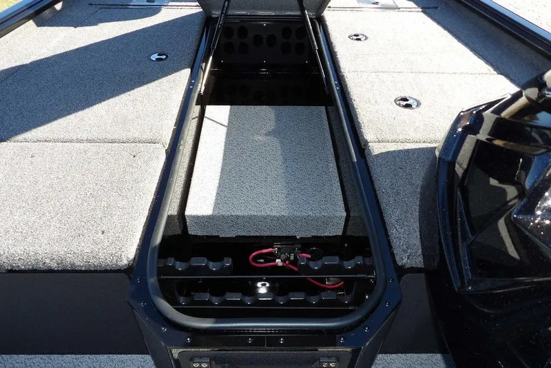 Slide: The Image of 2026 Lund 1875 Renegade boat interior with open storage compartment and carpeted deck. - 27