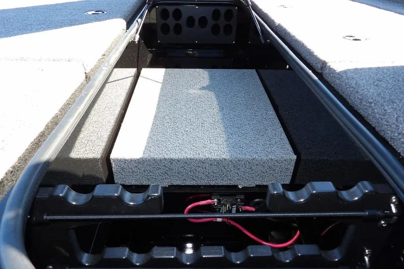 Slide: The Image of 2026 Lund 1875 Renegade boat interior storage compartment with carpeted surfaces. - 29