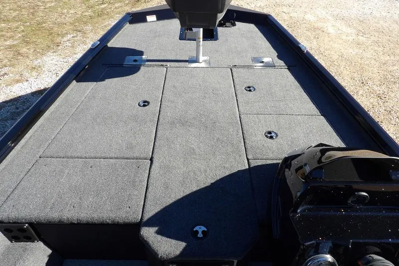 Slide: The Image of 2026 Lund 1875 Renegade boat interior with carpeted deck and storage compartments. - 30