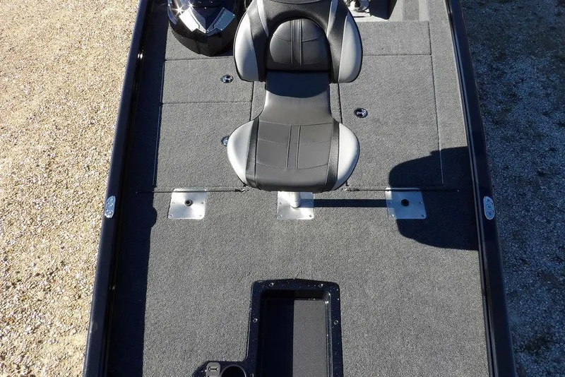 Slide: The Image of 2026 Lund 1875 Renegade boat interior with gray carpet and black seat. - 32