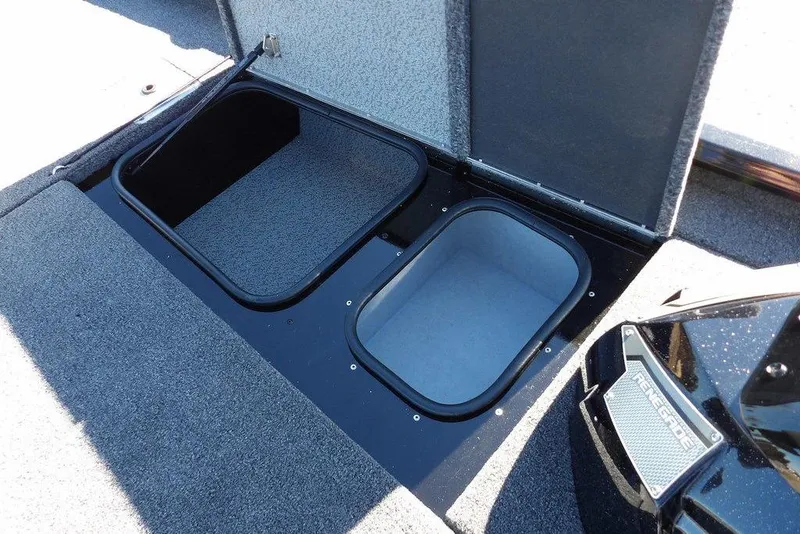 Slide: The Image of 2026 Lund 1875 Renegade boat storage compartments with open lids, showcasing interior space. - 35