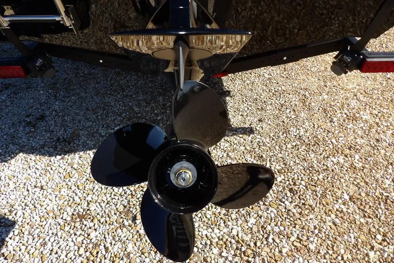 Slide: The Image of Propeller of 2026 Lund 1875 Renegade boat on gravel surface. - 37