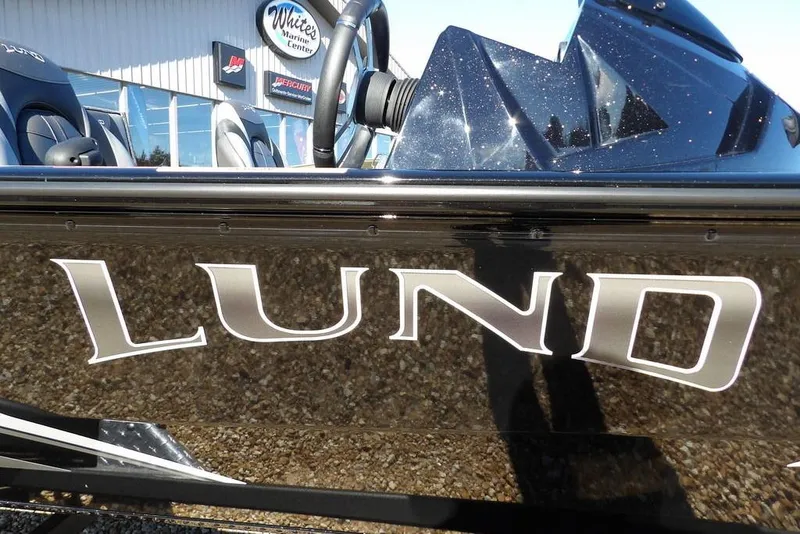 Slide: The Image of 2026 Lund 1875 Renegade boat exterior with logo, displayed at marine center. - 40