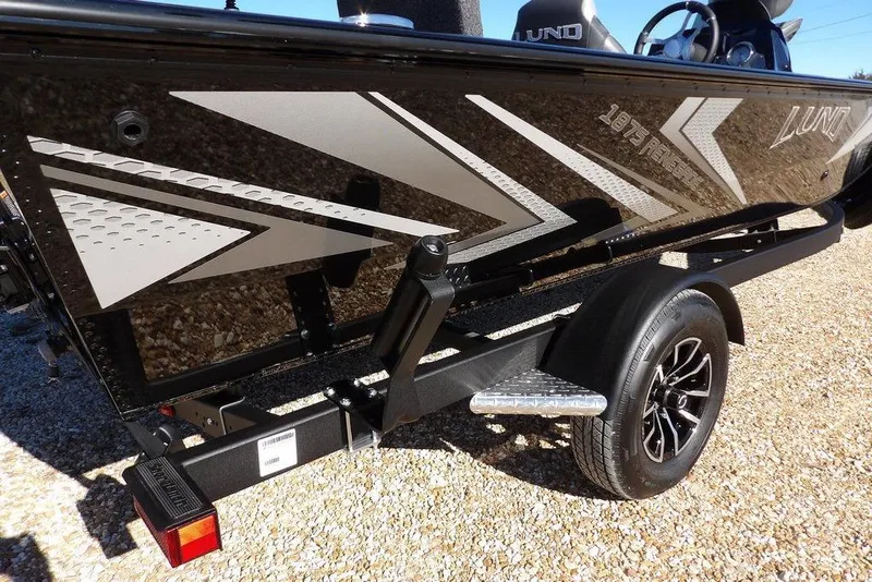 Slide: The Image of 2026 Lund 1875 Renegade boat on trailer, featuring sleek graphics and modern design. - 44