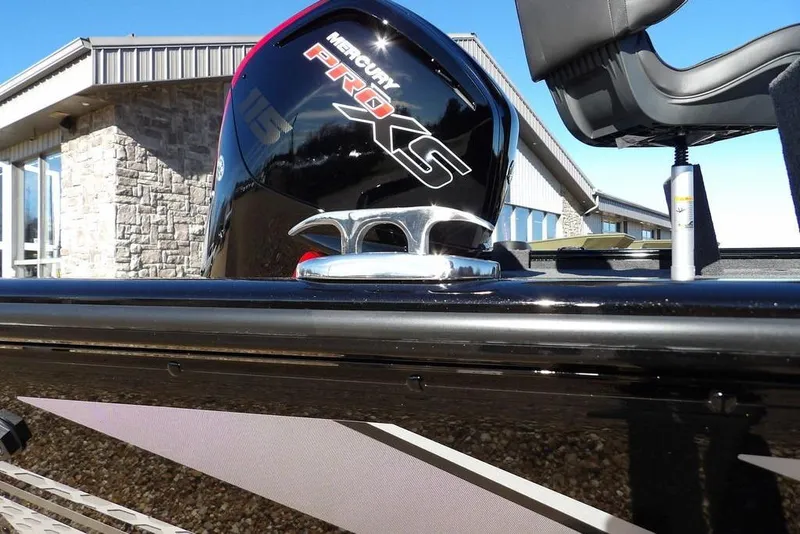 Slide: The Image of 2026 Lund 1875 Renegade boat with Mercury Pro XS engine, outdoor setting. - 45