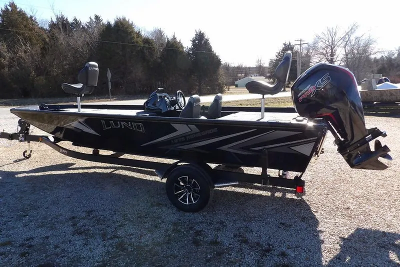 Slide: The Image of 2026 Lund 1875 Renegade fishing boat on trailer, featuring sleek design and powerful outboard motor. - 5