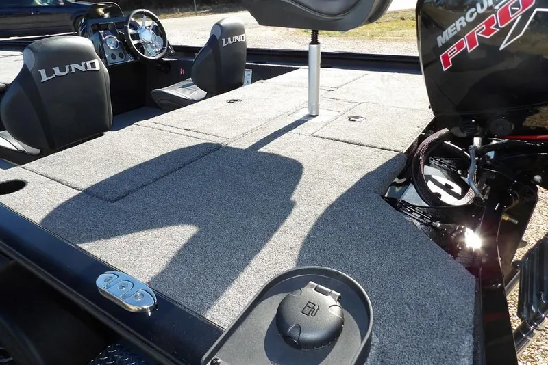 Slide: The Image of 2026 Lund 1875 Renegade boat interior with Mercury Pro motor, featuring spacious seating and controls. - 8