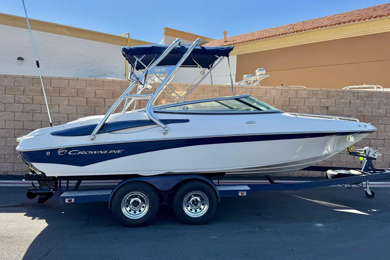 The Image of 2008 Crownline 21 SS boat on trailer, parked outdoors, side view. - 0