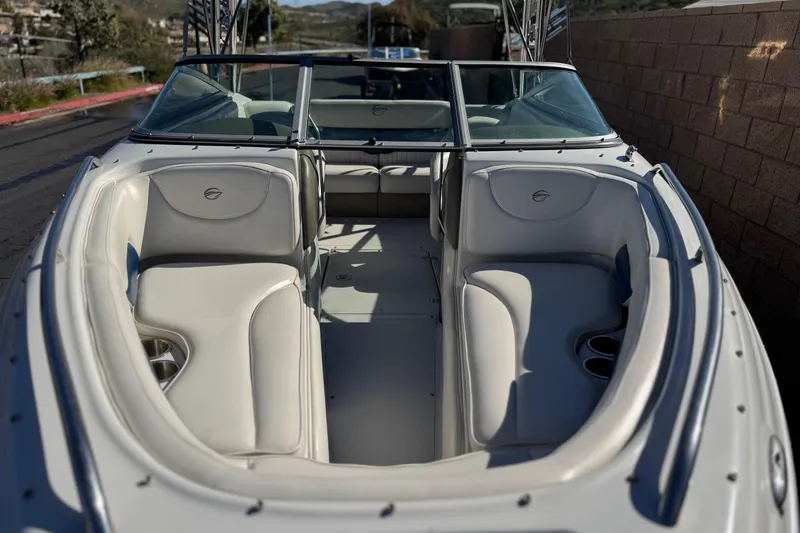 Slide: The Image of 2008 Crownline 21 SS boat interior with white seating and cup holders. - 11