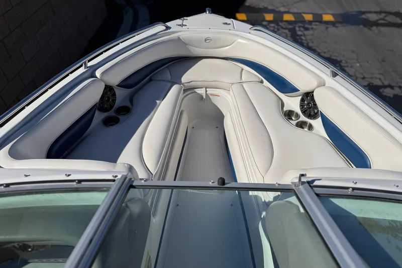 Slide: The Image of 2008 Crownline 21 SS boat interior with white and blue seating, cup holders, and speakers. - 14