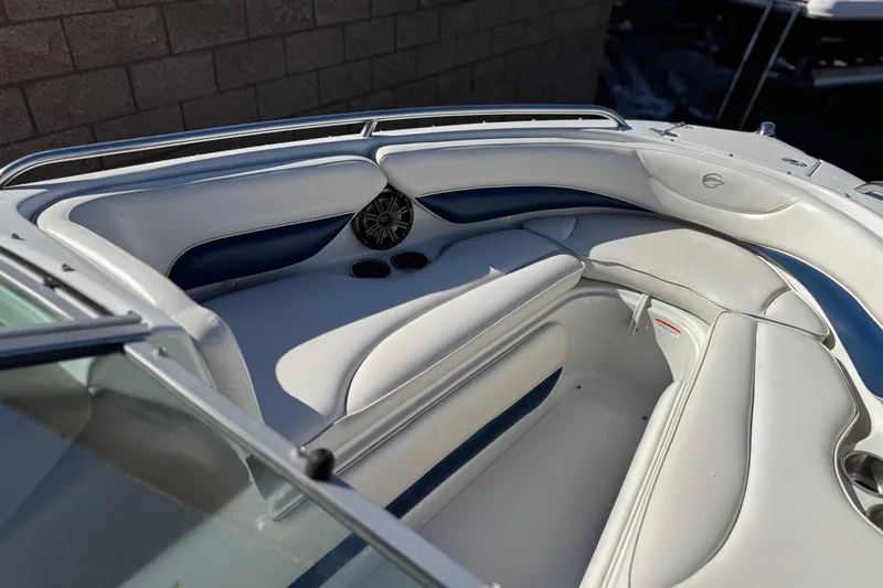 Slide: The Image of 2008 Crownline 21 SS boat interior with white and blue seating, cup holders, and speaker. - 15