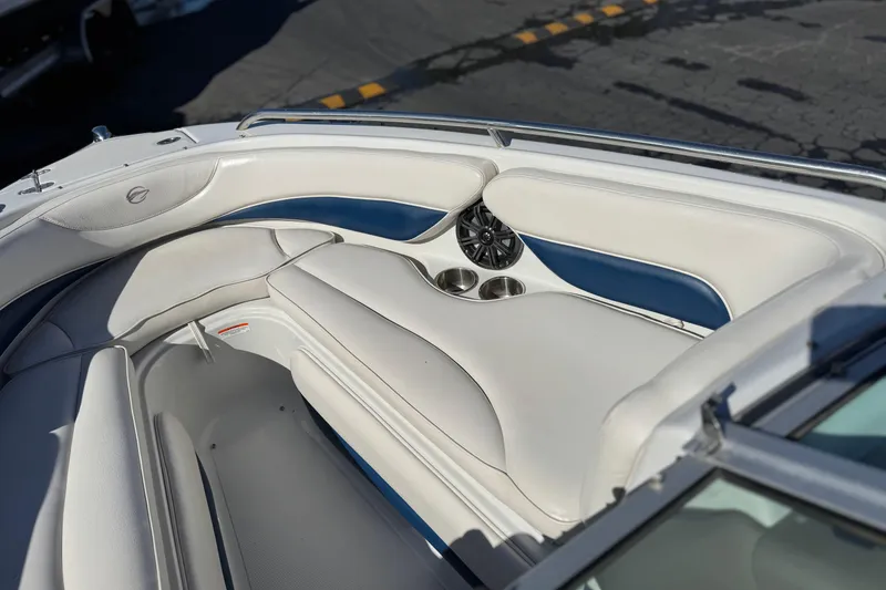 Slide: The Image of 2008 Crownline 21 SS boat interior with white and blue seating, cup holders, and speakers. - 16