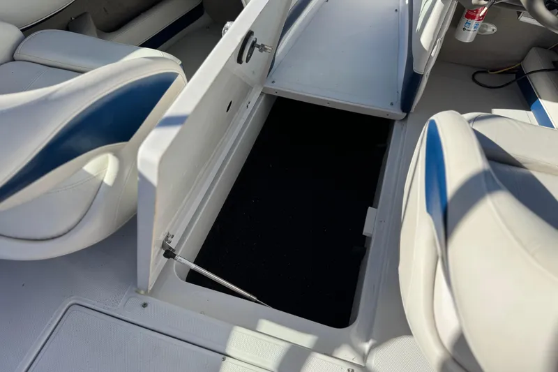 Slide: The Image of 2008 Crownline 21 SS boat interior storage compartment with open hatch and seating. - 23