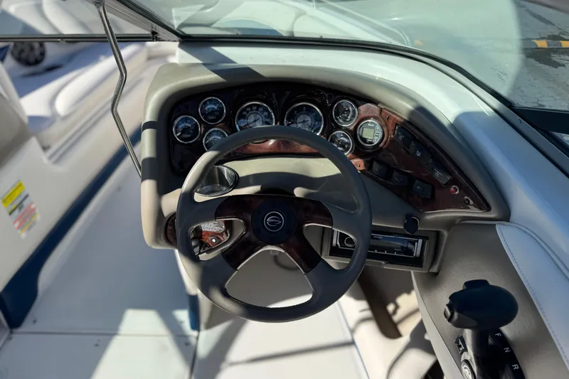 Slide: The Image of 2008 Crownline 21 SS boat dashboard with steering wheel and instrument panel. - 25