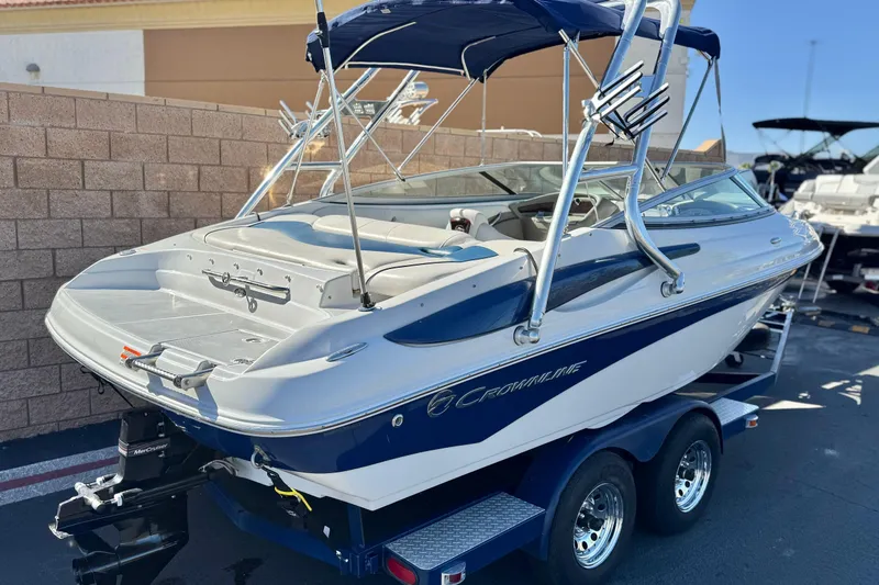 Slide: The Image of 2008 Crownline 21 SS boat on trailer, blue and white design, parked outdoors. - 5
