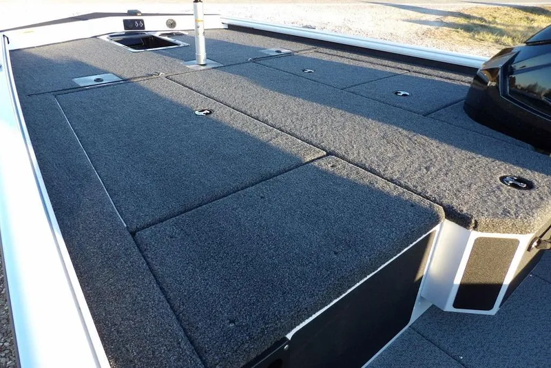 Slide: The Image of 2026 Lund 1875 Renegade boat deck with carpeted surface and storage compartments. - 11