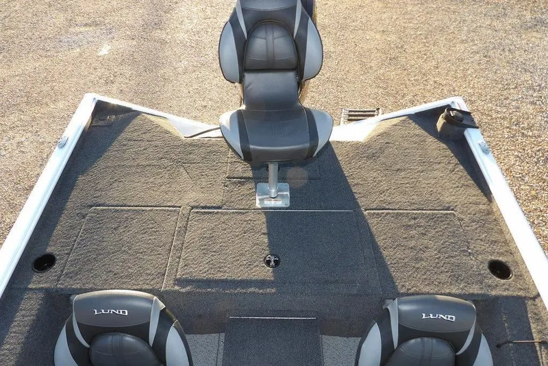 Slide: The Image of 2026 Lund 1875 Renegade boat interior with seating and carpeted deck. - 12