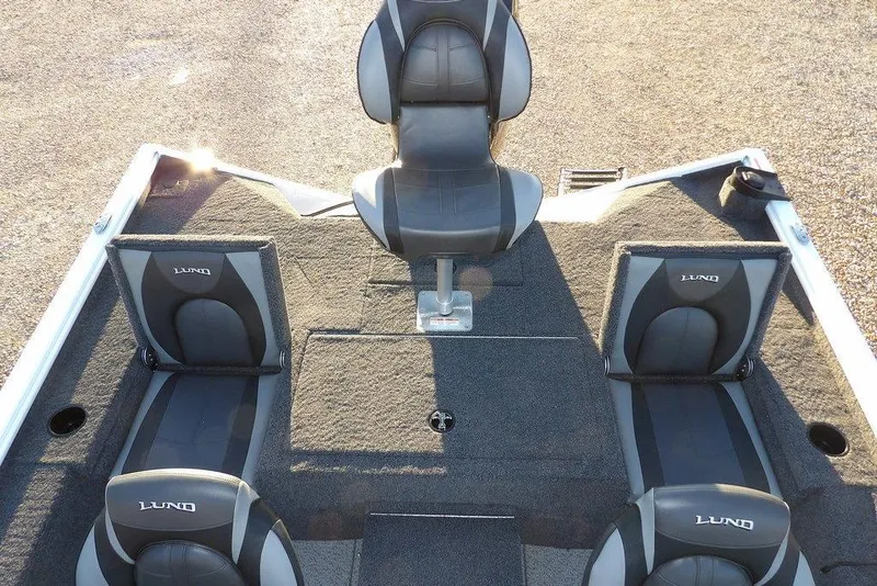 Slide: The Image of 2026 Lund 1875 Renegade boat interior with four cushioned seats, gray and black design. - 16