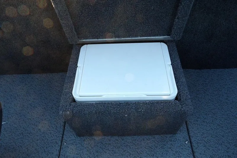 Slide: The Image of Storage compartment in 2026 Lund 1875 Renegade boat, featuring a white cooler. - 23