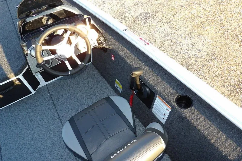 Slide: The Image of 2026 Lund 1875 Renegade boat interior with steering wheel and seat. - 26