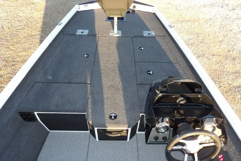 Slide: The Image of 2026 Lund 1875 Renegade boat interior with steering console and spacious deck layout. - 29