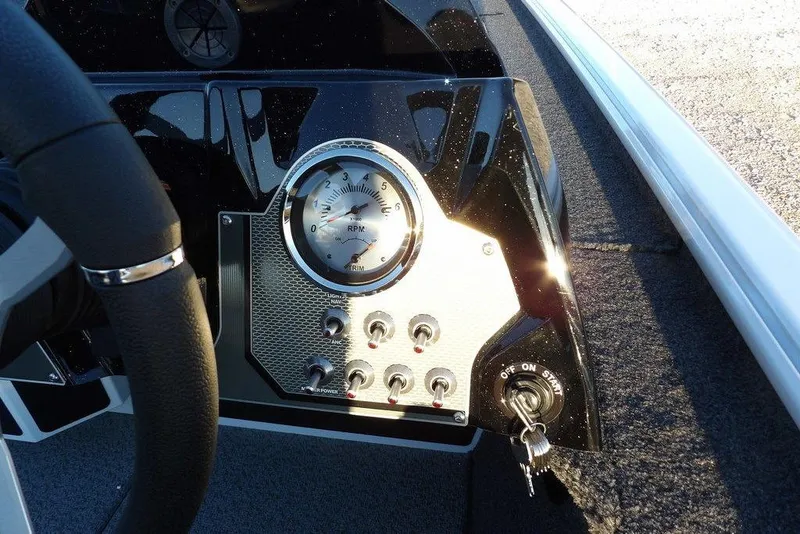 Slide: The Image of Dashboard of 2026 Lund 1875 Renegade boat with RPM gauge and ignition key. - 32