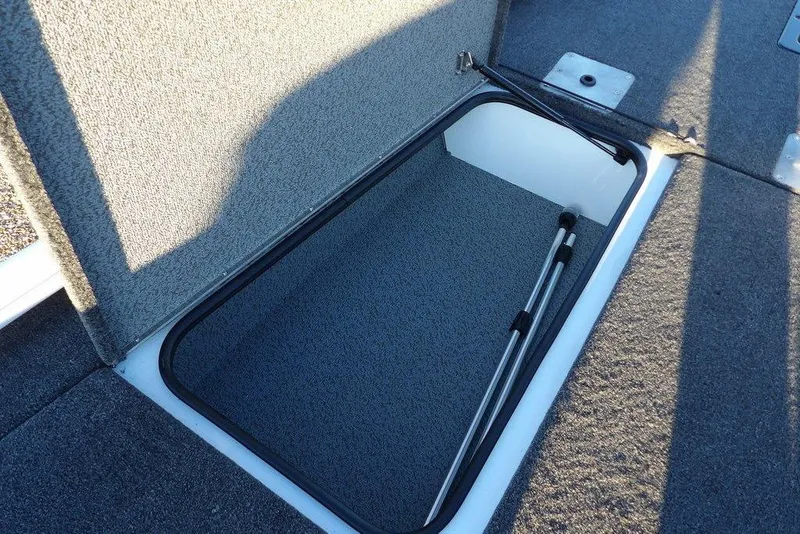 Slide: The Image of Open storage compartment in 2026 Lund 1875 Renegade boat, featuring carpeted interior. - 33