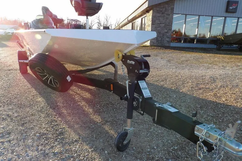 Slide: The Image of 2026 Lund 1875 Renegade boat on trailer, parked outside a building. - 38
