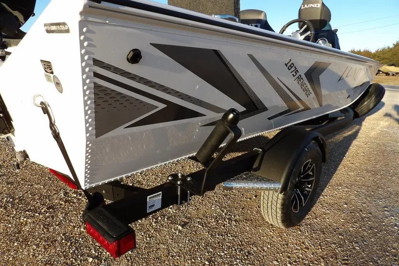 Slide: The Image of 2026 Lund 1875 Renegade boat on trailer, featuring sleek design and modern graphics. - 43
