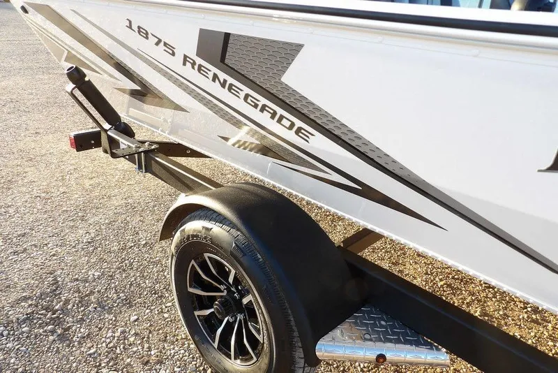 Slide: The Image of 2026 Lund 1875 Renegade boat on trailer, showcasing sleek design and modern graphics. - 44