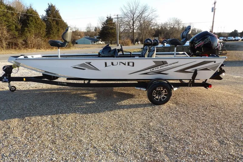 Slide: The Image of 2026 Lund 1875 Renegade fishing boat on trailer, parked outdoors. - 5