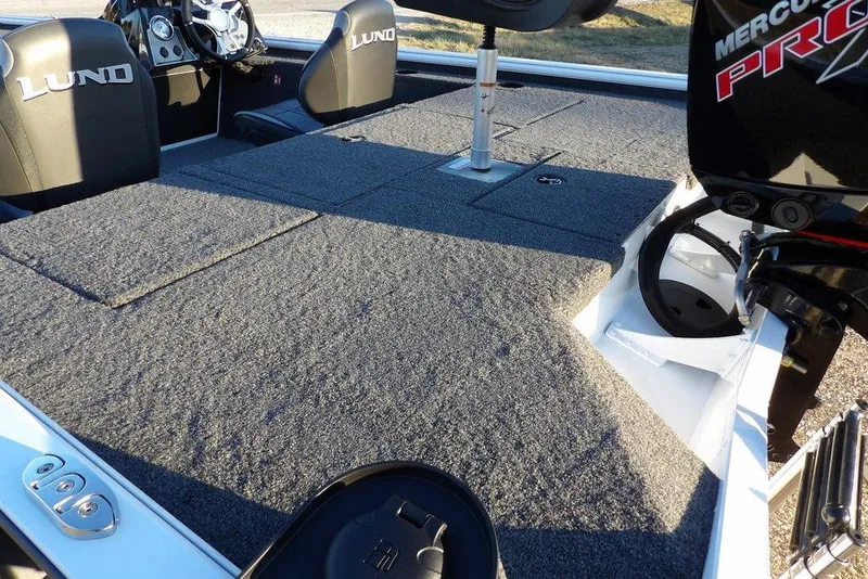 Slide: The Image of 2026 Lund 1875 Renegade boat interior with carpeted deck and Mercury Pro motor. - 9