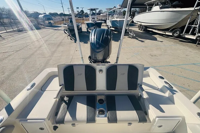Slide: The Image of 2021 Ranger 2510 Bay boat with seating and motor, parked in a marina. - 10