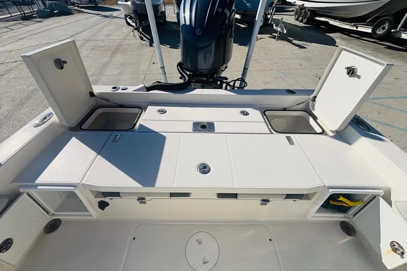 Slide: The Image of 2021 Ranger 2510 Bay boat deck with storage compartments open, showcasing spacious design. - 11