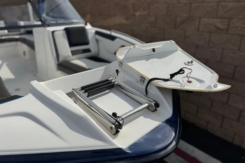 Slide: The Image of 2020 Yamaha AR210 boat with open hatch and ladder, showcasing interior seating. - 13