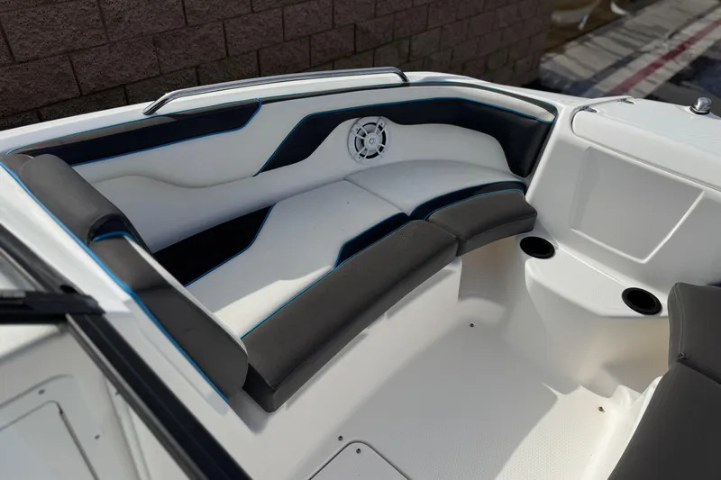 Slide: The Image of 2020 Yamaha AR210 boat interior with cushioned seating and cup holders. - 15