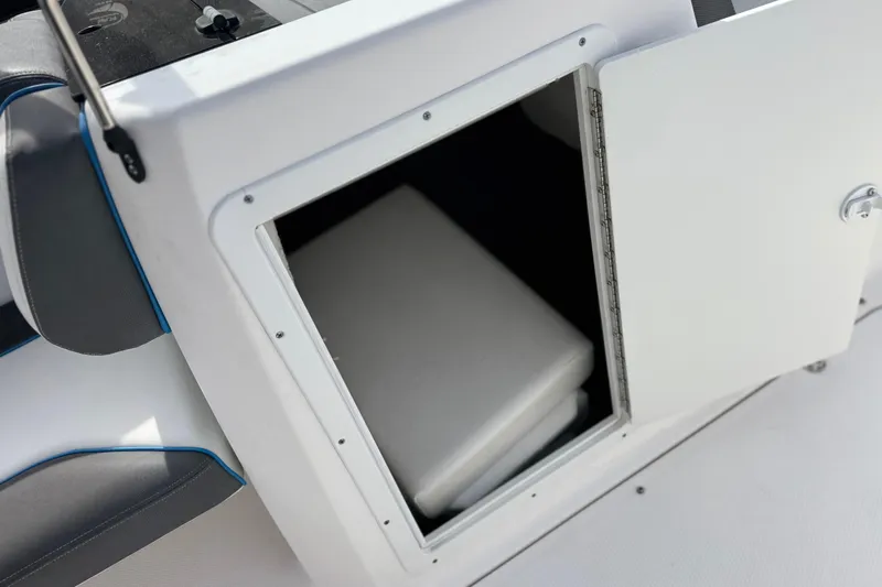 Slide: The Image of 2020 Yamaha AR210 boat storage compartment with open door, revealing interior space. - 24