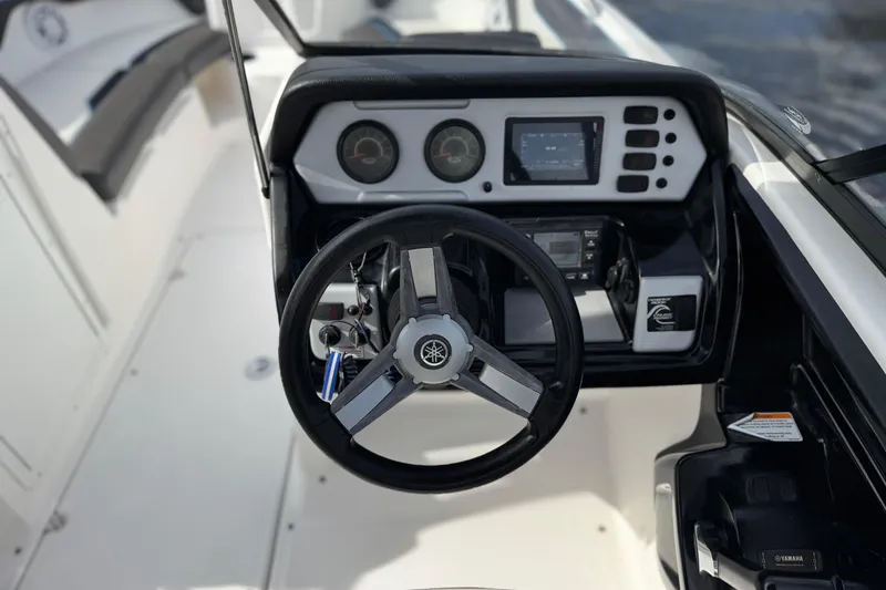Slide: The Image of 2020 Yamaha Boats AR210 dashboard with steering wheel and control panel. - 26