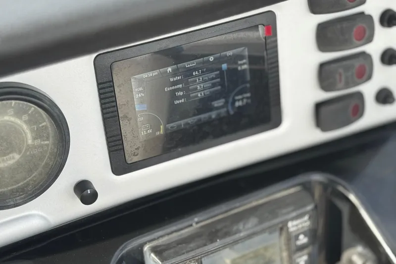 Slide: The Image of Dashboard of a 2020 Yamaha AR210 boat with digital display and controls. - 28